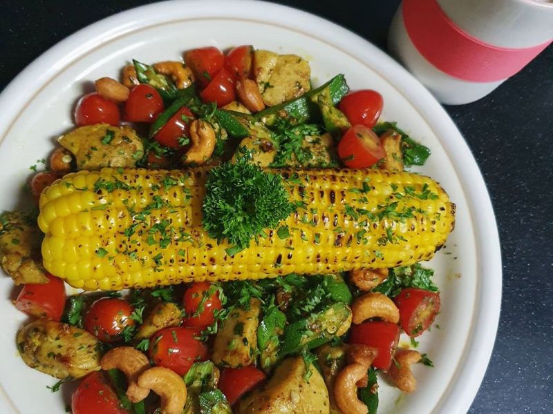 Stir fried turmeric chicken with lady finger. Grilled corn on cob with butter and&nbsp;pepper.