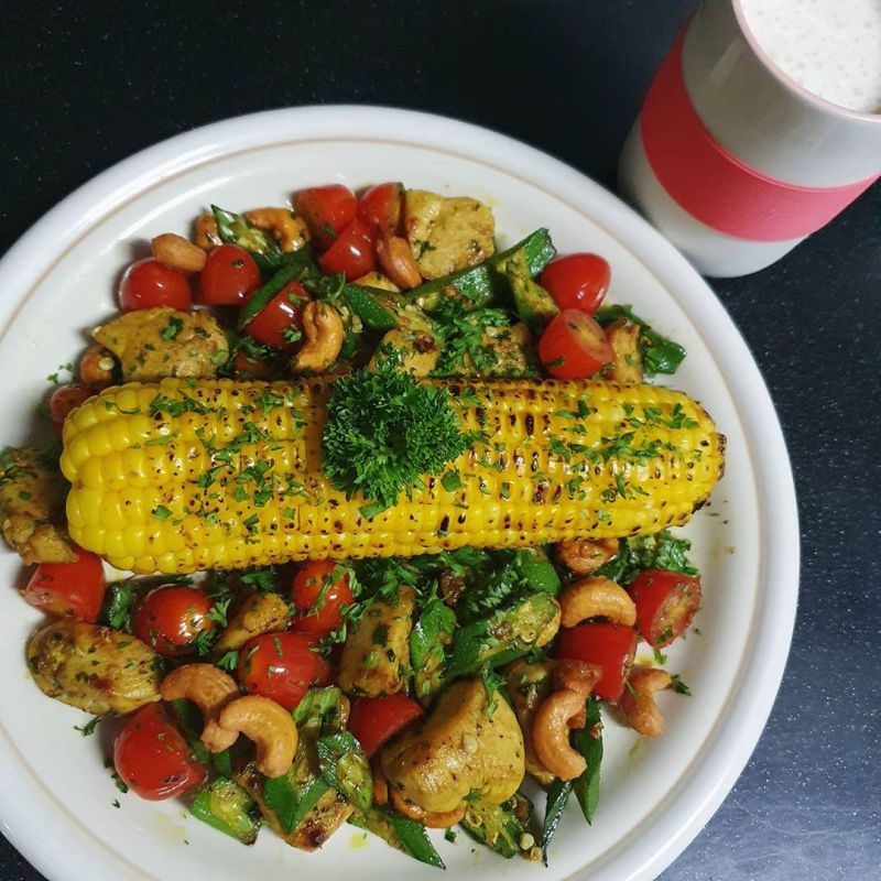 Stir fried turmeric chicken with lady finger. Grilled corn on cob with butter and&nbsp;pepper.
